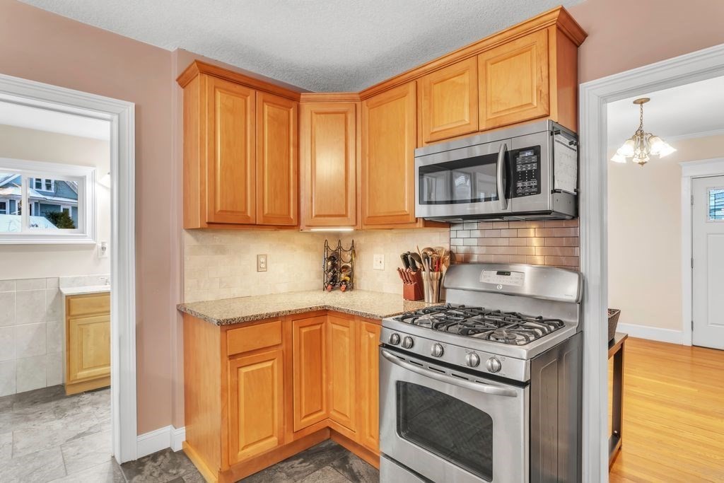 754 White Street Springfield, MA 01108 - Photo 6 of 41 a kitchen with stainless steel appliances granite countertop a stove and a microwave