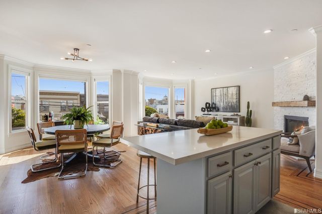 a kitchen with a sink a counter and chairs