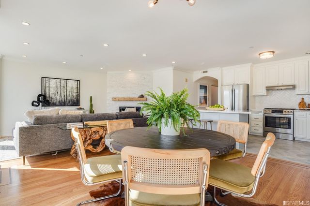 a dining room with furniture and wooden floor