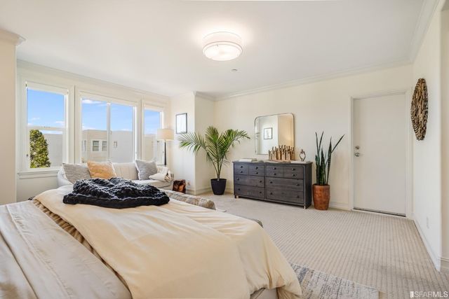 a bed room with a bed and a potted plant