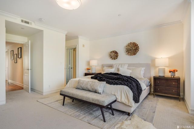 a bedroom with a bed and cabinets