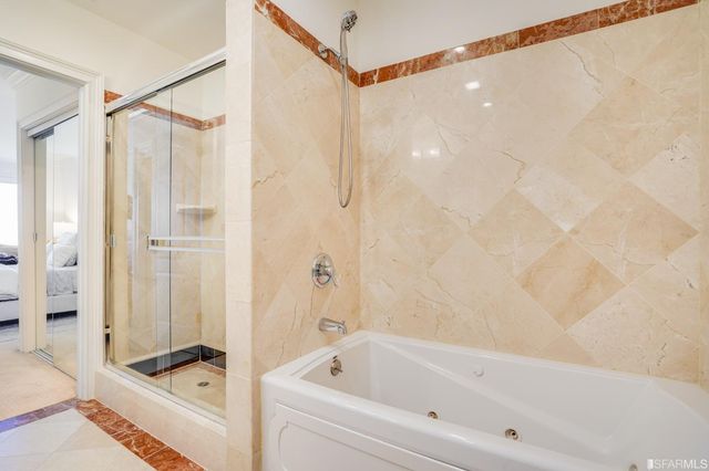 a bathroom with a bathtub and a shower