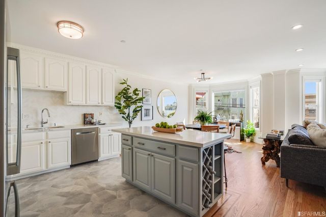 a kitchen with sink stove and cabinets