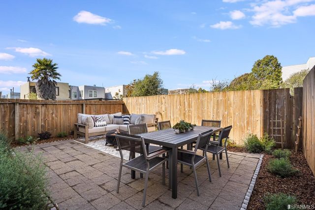 a view of a dinning table and chairs in the patio