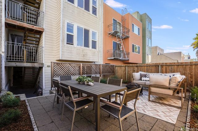 a view of a patio with a table and chairs