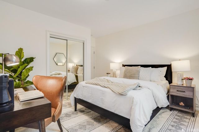 a bedroom with bed and a table