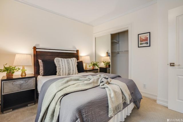 a bedroom with a bed and a lamp