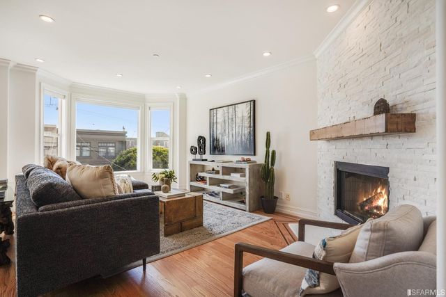 a living room with furniture fireplace and flat screen tv