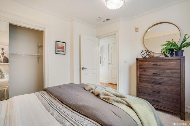 a bedroom with a bed and a dresser