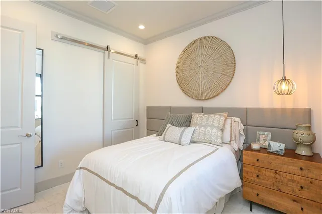 a bedroom with a bed and a mirror