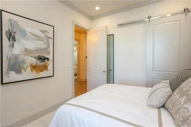 a bedroom with a large bed and a painting on the wall