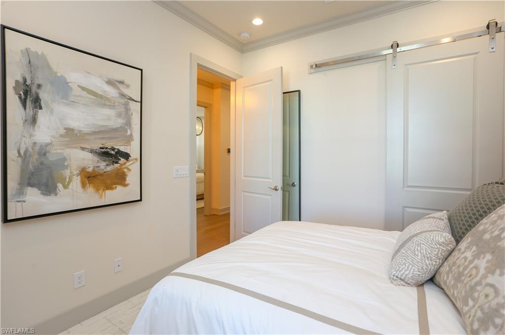 14727 Kingfisher Loop Naples, FL 34120 - Photo 15 of 50 a bedroom with a large bed and a painting on the wall