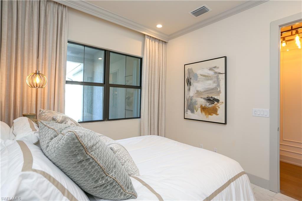 14727 Kingfisher Loop Naples, FL 34120 - Photo 16 of 50 a bedroom with a bed and a window