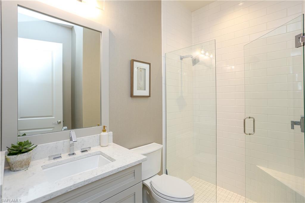 14727 Kingfisher Loop Naples, FL 34120 - Photo 17 of 50 a bathroom with a sink a toilet and shower