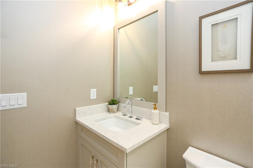 14727 Kingfisher Loop Naples, FL 34120 - Photo 18 of 50 a bathroom with a sink and a toilet