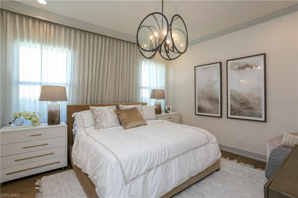 14727 Kingfisher Loop Naples, FL 34120 - Photo 19 of 50 a bedroom with bed and a chandelier
