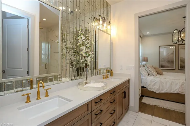 a bathroom with double vanity sinks and a mirror