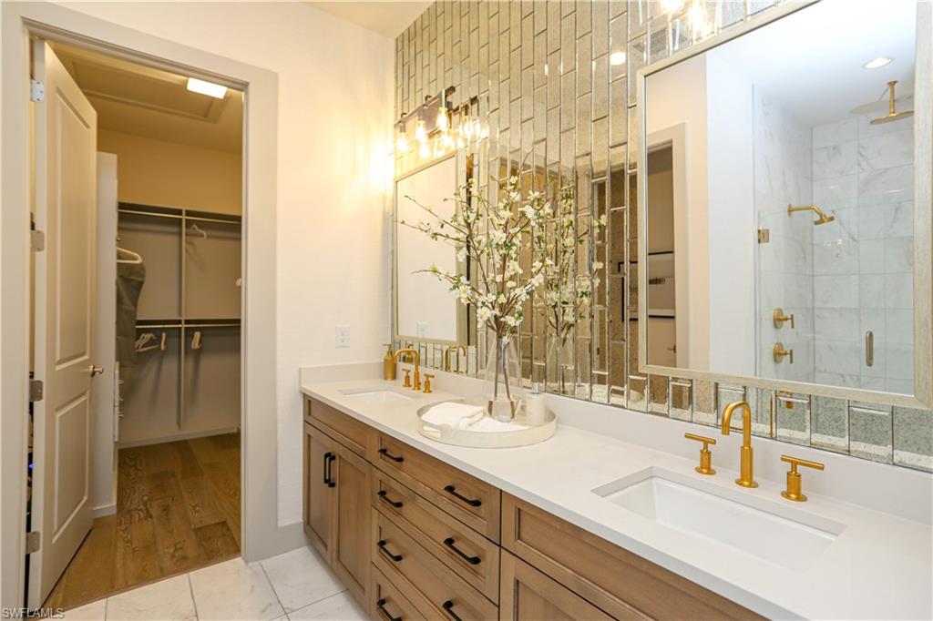14727 Kingfisher Loop Naples, FL 34120 - Photo 27 of 50 a bathroom with double vanity sink and a mirror