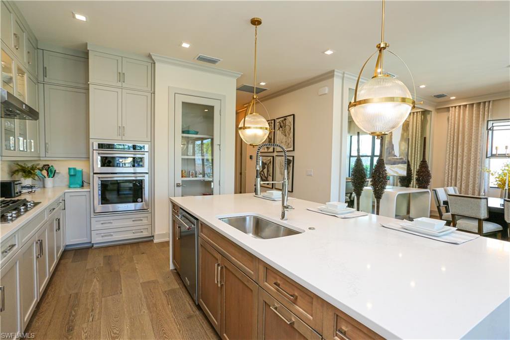 14727 Kingfisher Loop Naples, FL 34120 - Photo 31 of 50 a large kitchen with kitchen island a large island in it