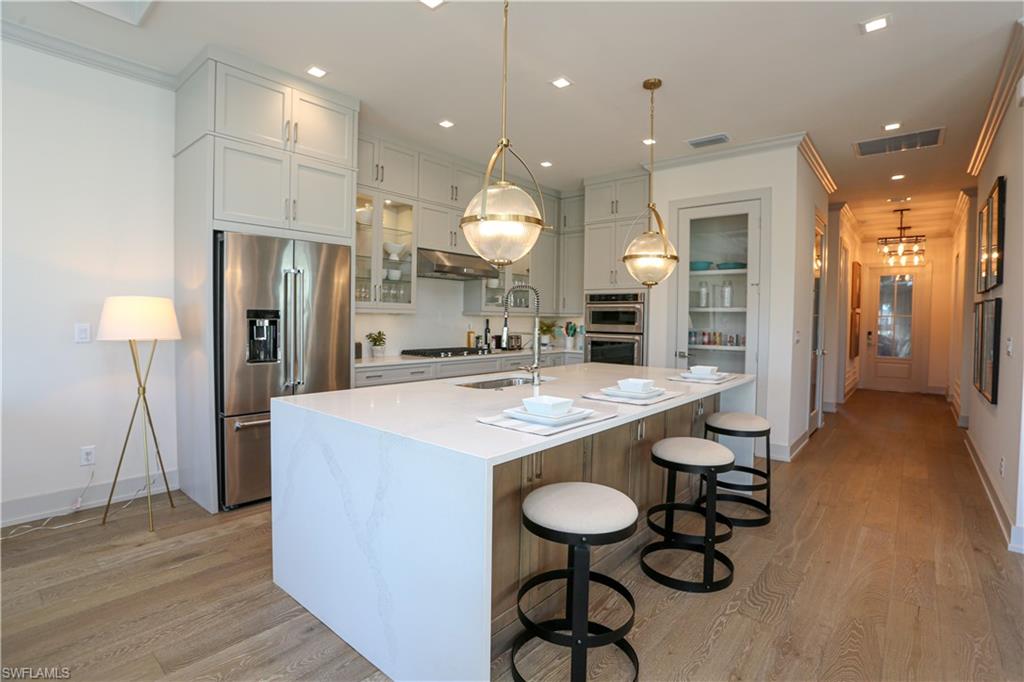 14727 Kingfisher Loop Naples, FL 34120 - Photo 33 of 50 a large kitchen with a table and chairs