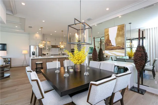 a dining room with furniture and wooden floor
