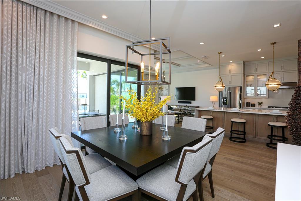 14727 Kingfisher Loop Naples, FL 34120 - Photo 37 of 50 a dining room with furniture window and wooden floor