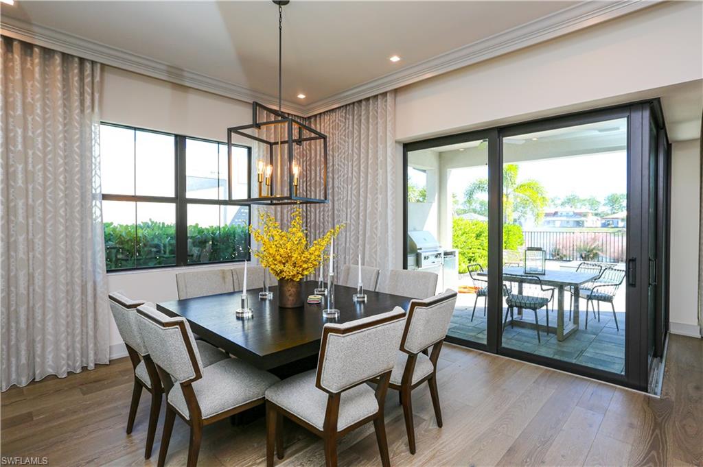 14727 Kingfisher Loop Naples, FL 34120 - Photo 47 of 50 a view of a dining room with furniture window and wooden floor