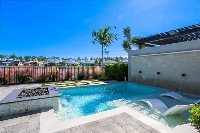 a house with swimming pool in front of it