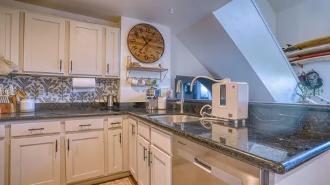 a kitchen with stainless steel appliances granite countertop a refrigerator sink and cabinets