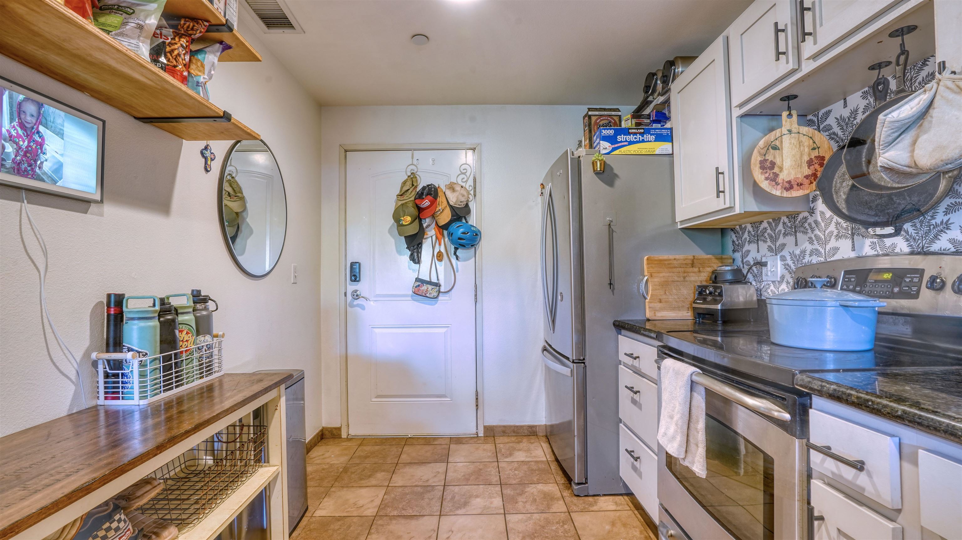 3710 Lower Honoapiilani Road, Unit F44 Lahaina, HI 96761 - Photo 13 of 41 a kitchen with stainless steel appliances granite countertop a sink and a refrigerator