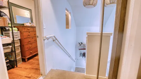 a bedroom with wooden floor and bed