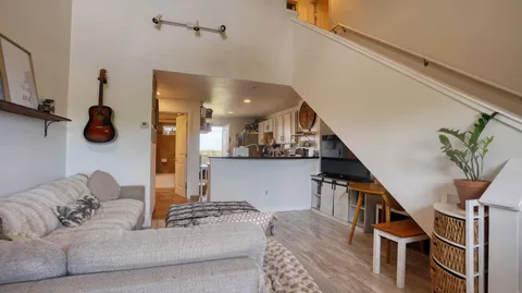 a living room with furniture and stairs