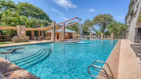 a view of swimming pool with outdoor seating
