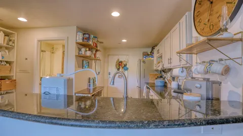 a kitchen with stainless steel appliances granite countertop a sink and a stove