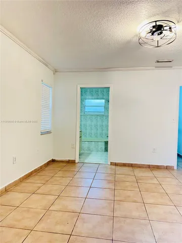 a view of a room with an empty space and a window