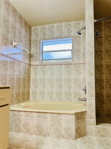 a bathroom with a bathtub and shower