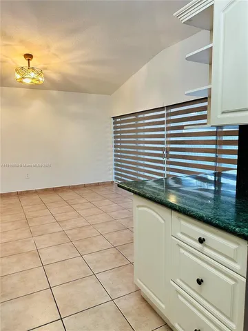 a view of kitchen and empty room
