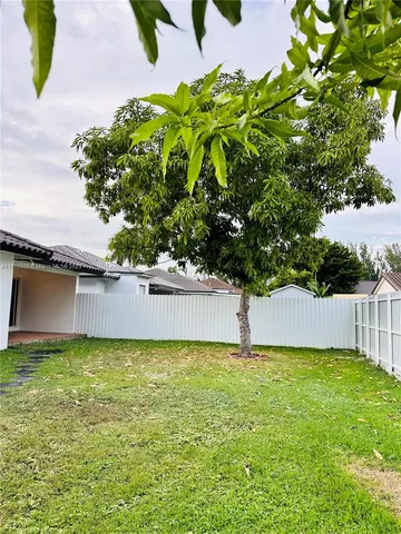 a house with green field in front of it