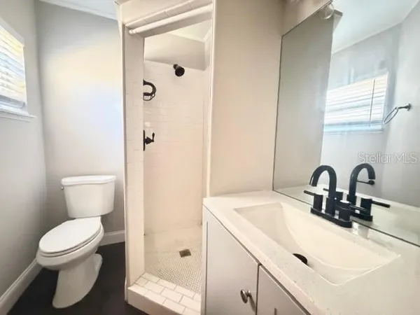 a bathroom with a sink toilet and shower