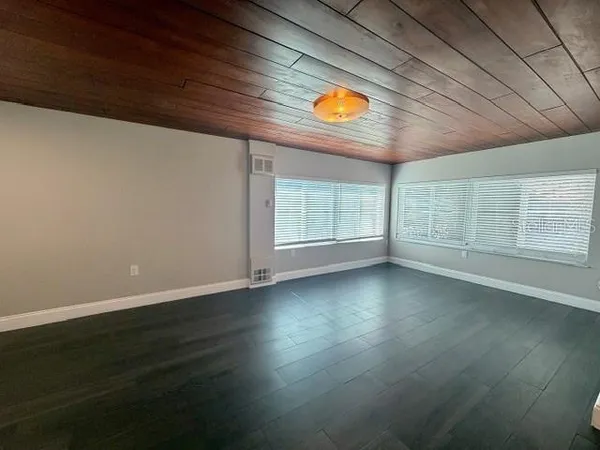 an empty room with a empty space and windows