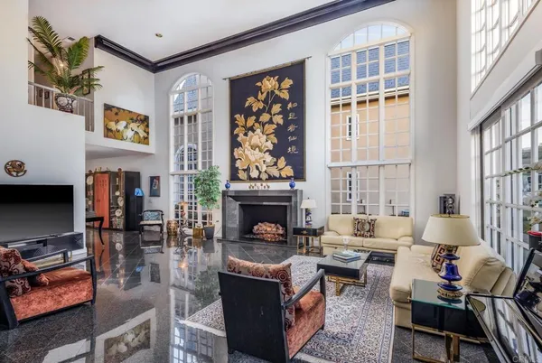 a living room with furniture a fireplace and a window