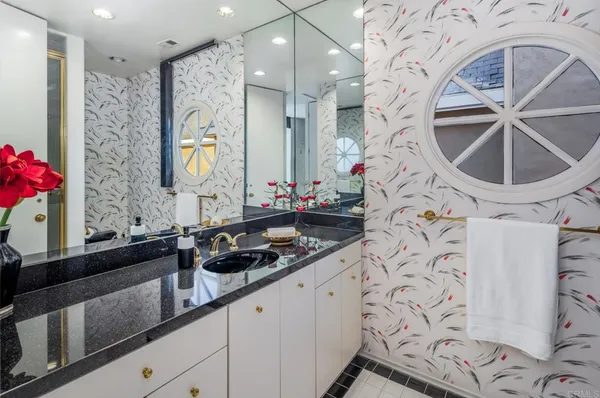 a bathroom with a sink and a mirror with painted walls