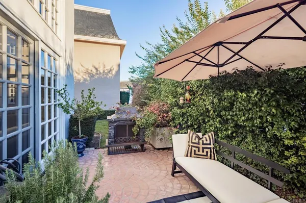 a view of a patio with table and chairs and potted plants