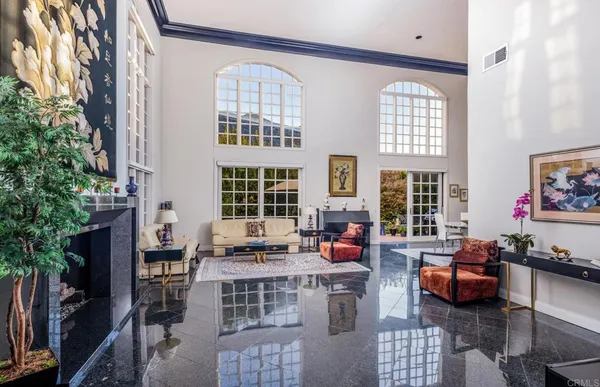 a living room with furniture fireplace and lots of windows