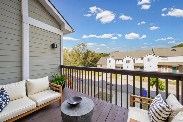 a balcony with furniture and a potted plant