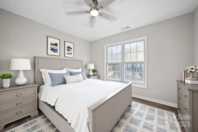 a spacious bedroom with a bed and a window