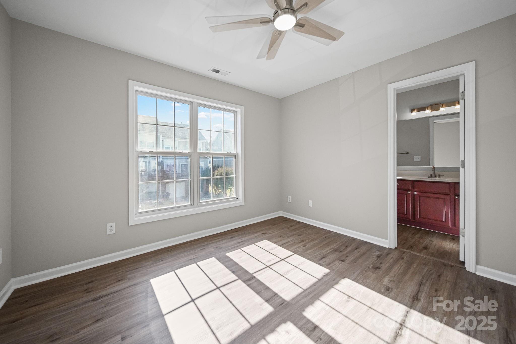 115 Sun Ridge Drive Mooresville, NC 28117 - Photo 19 of 30 a view of an empty room with a window and wooden floor