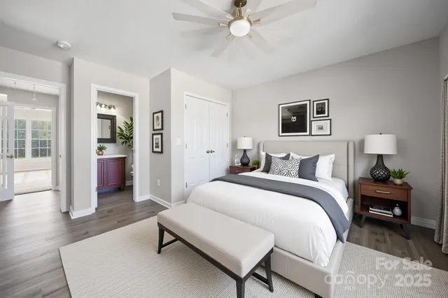 a bedroom with a bed and a chandelier