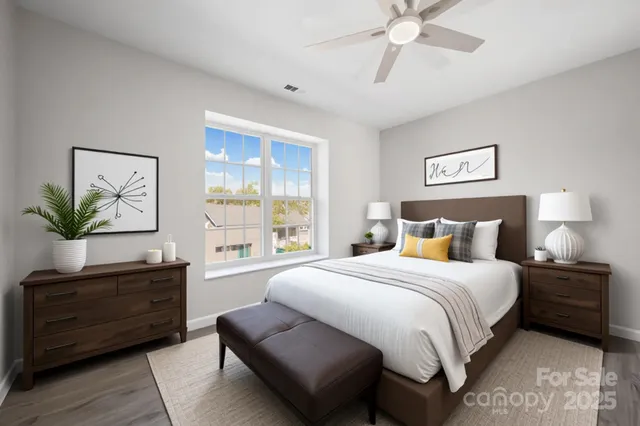 a bedroom with a bed a chandelier and a window