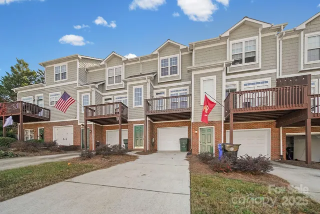 a front view of a residential apartment building with a yard